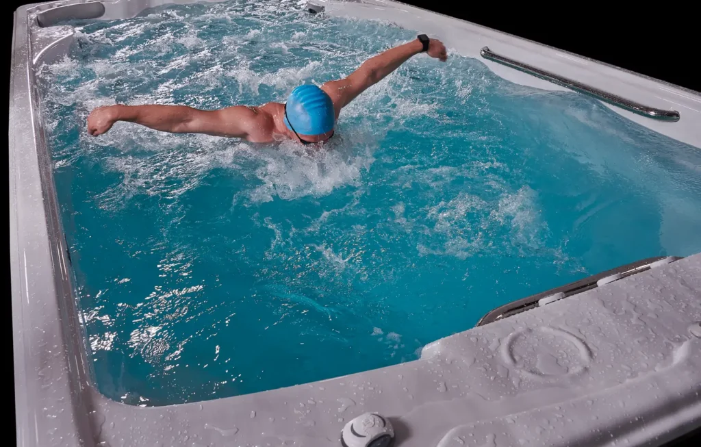man swimming in swim spa against current