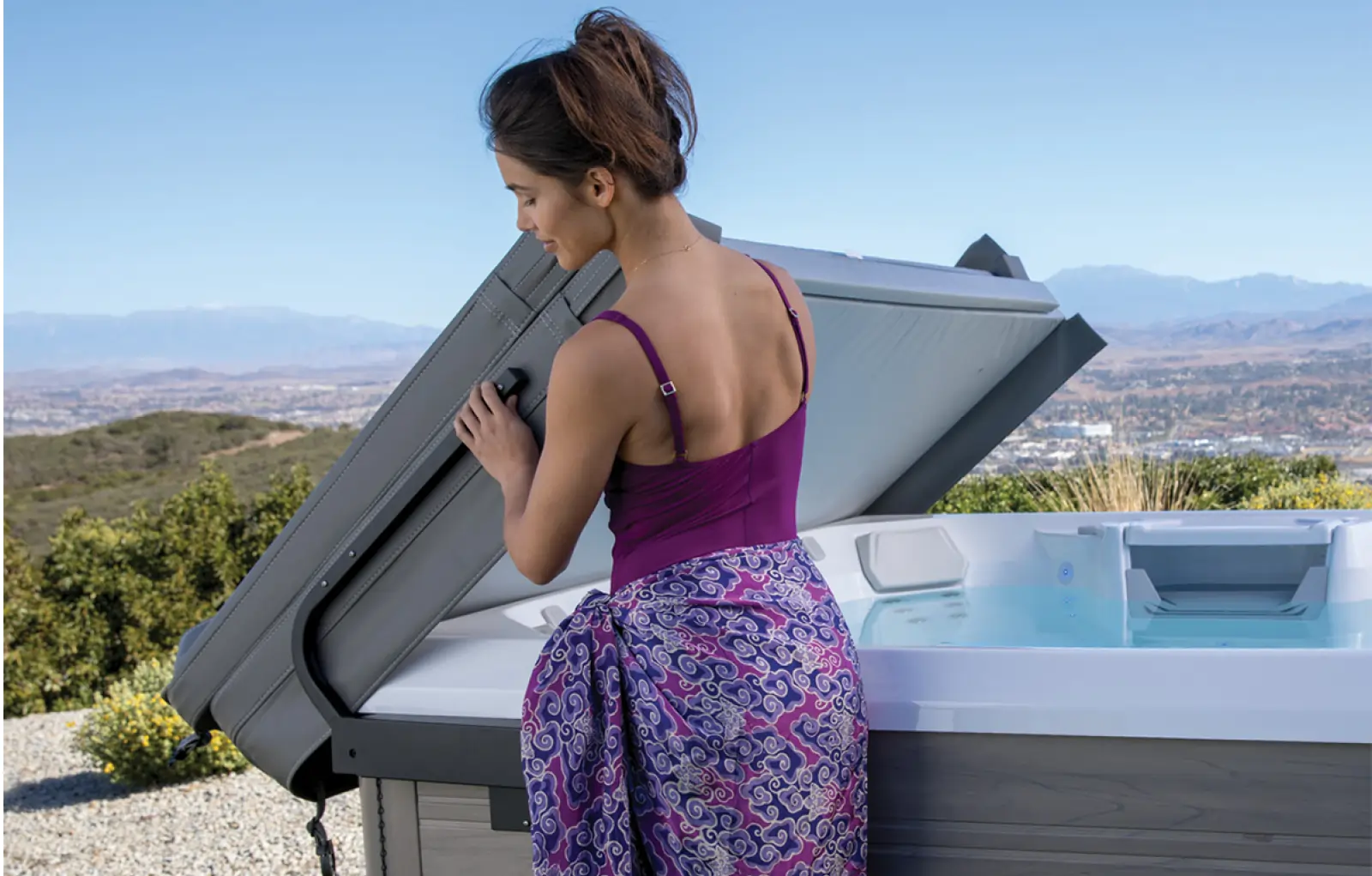 Women using hot tub cover lift